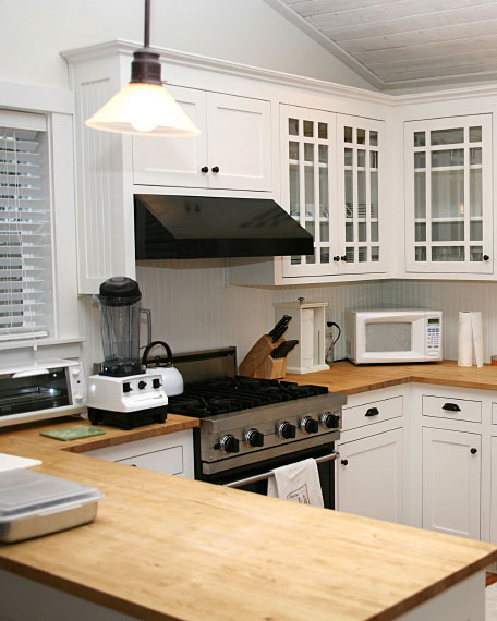 Kitchen With Wood Countertops And White Cabinets