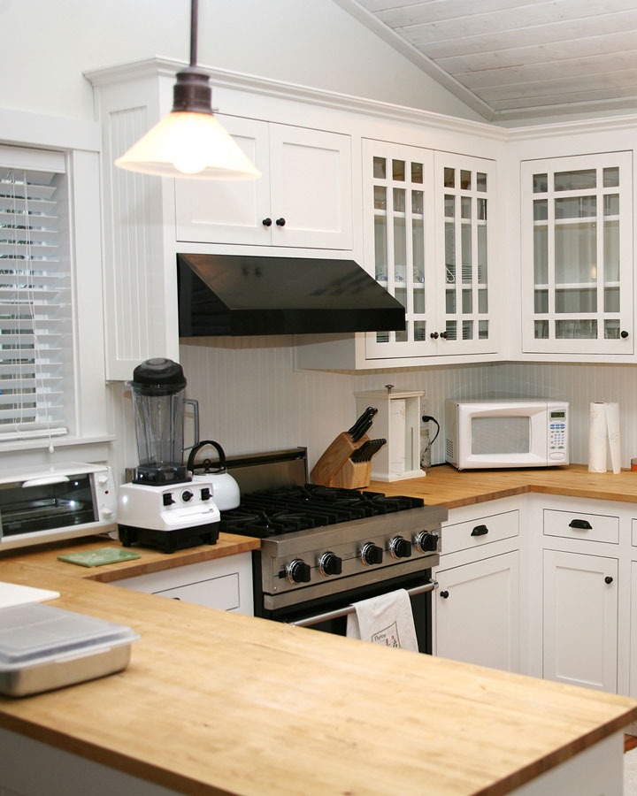 wood, butcher block countertops and white kitchen cabinets
